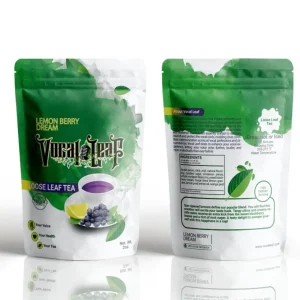 Front and back view of Vocal Leaf Lemon Berry Dream loose leaf tea pouch featuring green watercolor design, a cup of purple tea, blueberries, and lemon.